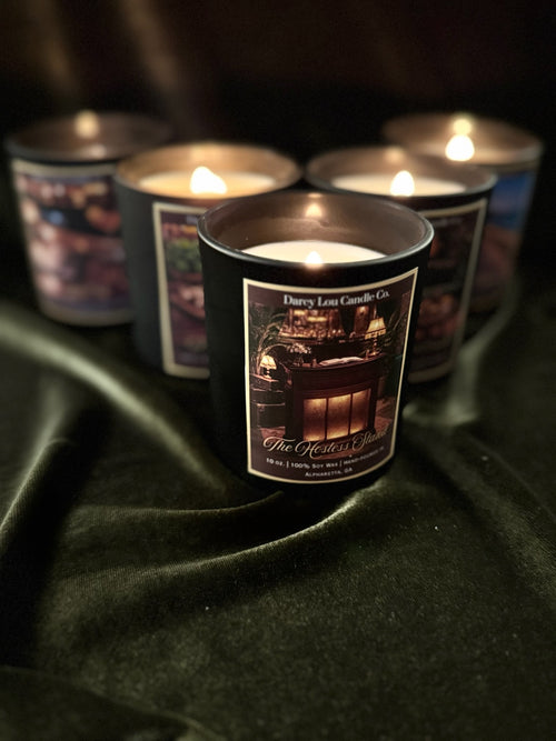 Candle with a label on a dark surface