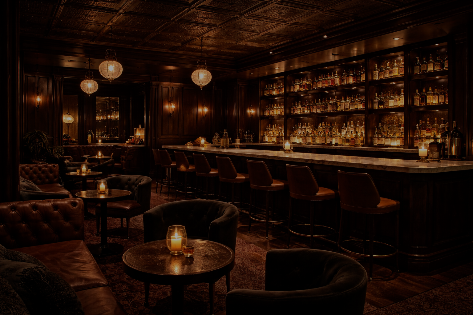 Dark and cozy bar interior with dim lighting, leather chairs, and a well-stocked bar.