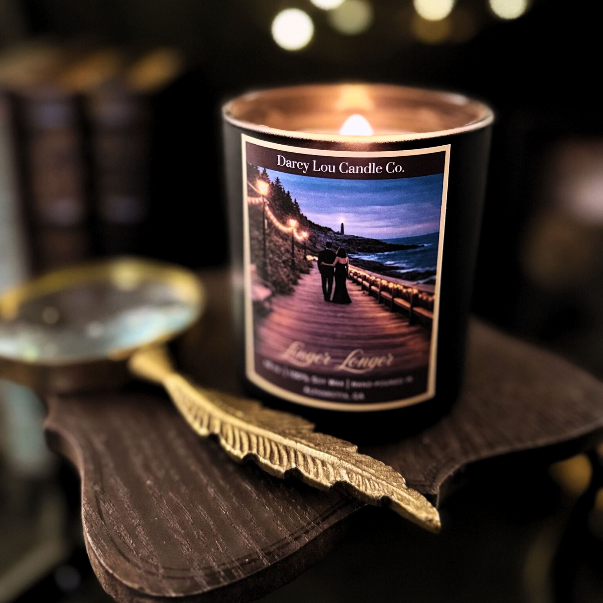 Candle from Darcy Lou Candle Co. on a wooden surface with a blurred background
